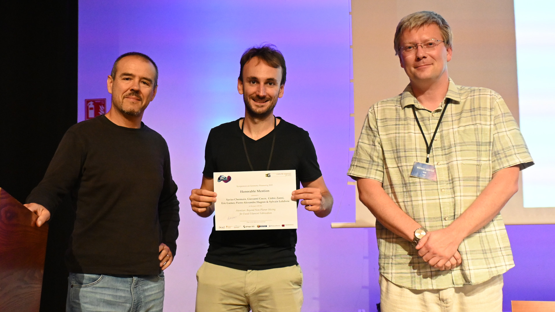 Me with the Honorable Mention diploma from SGP, together with the Program Chair and the Local Organizer.